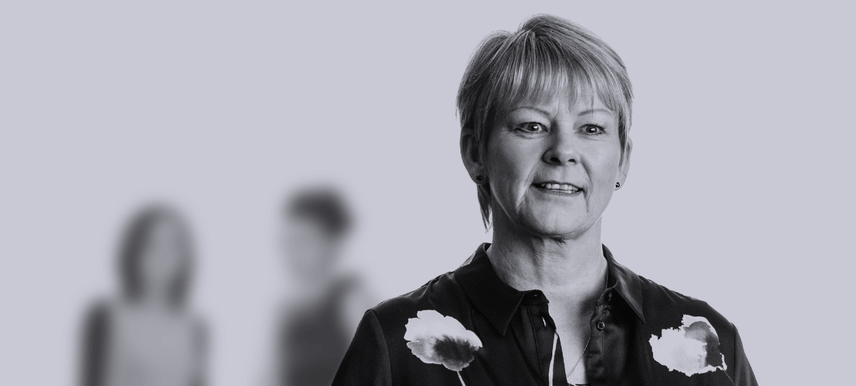 A headshot of a GatenbySanderson employee smiling to camera