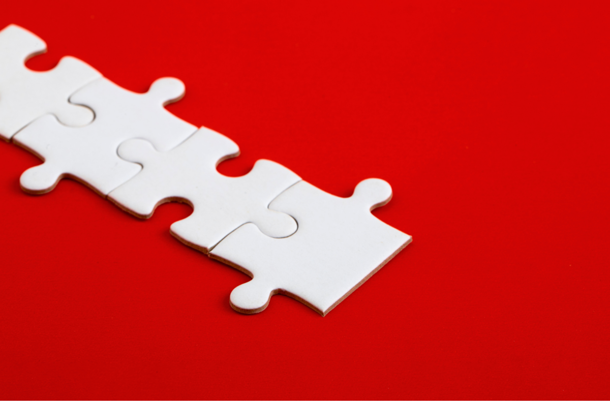 white puzzle pieces on red background